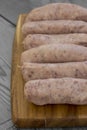 Raw pork sausages on a chopping board Royalty Free Stock Photo
