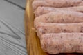 Raw pork sausages on a chopping board Royalty Free Stock Photo