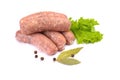 Raw pork sausages. Grilled sausages, spices close-up, isolated on a white background.Selective focus Royalty Free Stock Photo
