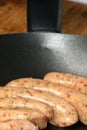 Raw pork sausages in a pan Royalty Free Stock Photo