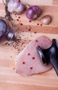 Raw pork schnitzel with meat tenderizer on wooden Royalty Free Stock Photo