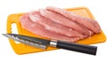 Raw pork schnitzel on plastic cutting board and kitchen knife isolated on white Royalty Free Stock Photo