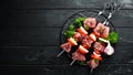 Raw pork shish kebab. BBQ meat with vegetables and spices. Top view. Royalty Free Stock Photo