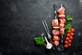 Raw pork shish kebab. BBQ meat with vegetables and spices. Top view. Royalty Free Stock Photo