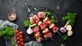 Raw pork shish kebab. BBQ meat with vegetables and spices. Top view. Free space for your text. Royalty Free Stock Photo