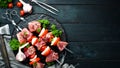 Raw pork shish kebab. BBQ meat with vegetables and spices. Top view. Free space for your text. Royalty Free Stock Photo