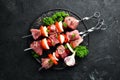 Raw pork shish kebab. BBQ meat with vegetables and spices. Top view. Free space for your text. Royalty Free Stock Photo