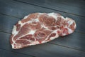 Raw pork shoulder chop on wooden board