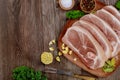 Raw pork shoulder sliced with skin and bone on wooden table Royalty Free Stock Photo