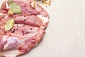 Raw pork shoulder with spices. Bay leaf, garlic. On a stone background Royalty Free Stock Photo