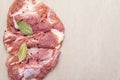 Raw pork shoulder with spices. Bay leaf, garlic. On a stone background Royalty Free Stock Photo