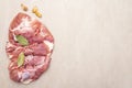 Raw pork shoulder with spices. Bay leaf, garlic. On a stone background Royalty Free Stock Photo