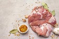 Raw pork shoulder with spices. Bay leaf, garlic. On a stone background Royalty Free Stock Photo