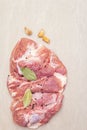 Raw pork shoulder with spices. Bay leaf, garlic. On a stone background Royalty Free Stock Photo