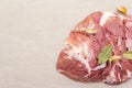 Raw pork shoulder with spices. Bay leaf, garlic. On a stone background Royalty Free Stock Photo
