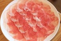 Raw pork sliced in white dish for shabushabu, Japanese recipe