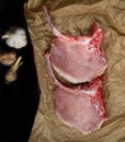 raw pork steak, garlic, aromatic spices on paper Royalty Free Stock Photo