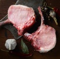 Raw pork steak, garlic, aromatic spices on a wooden background