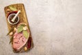 Raw pork steak with spices and dried herbs on vintage wooden board. Salt, garlic, hot pepper, rosemary, bay leaf with ceramic Royalty Free Stock Photo