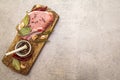 Raw pork steak with spices and dried herbs on vintage wooden board. Salt, garlic, hot pepper, rosemary, bay leaf with ceramic Royalty Free Stock Photo