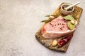 Raw pork steak with spices and dried herbs on vintage wooden board. Salt, garlic, hot pepper, rosemary, bay leaf with ceramic Royalty Free Stock Photo