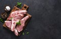 Raw pork steaks on a board with spices and basil on a dark background. Top view. Fresh meat. Ribs Royalty Free Stock Photo