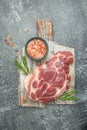 Raw pork steaks on a cutting board with spices Raw meat pork steaks with seasoning. place for text, top view Royalty Free Stock Photo