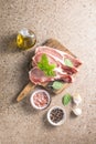 Raw pork  steaks with spices, herbs on cutting  board. Fresh meat. Top view copy space Royalty Free Stock Photo