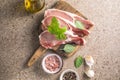 Raw pork  steaks with spices, herbs on cutting  board. Fresh meat. Top view copy space Royalty Free Stock Photo