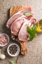 Raw pork  steaks with spices, herbs on cutting  board. Fresh meat. Top view copy space Royalty Free Stock Photo