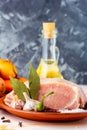 Raw pork tenderloin, ready to roast, with spices, black pepper, olive oil, garlic, bay leaf, salt Royalty Free Stock Photo