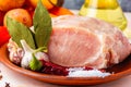 Raw pork tenderloin, ready to roast, with spices, black pepper, olive oil, garlic, bay leaf, salt Royalty Free Stock Photo