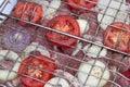 Raw pork, tomatoes and onions in grid for bbq Royalty Free Stock Photo
