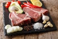 Raw porterhouse beef steak with ingredients close-up. horizontal Royalty Free Stock Photo