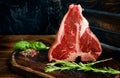 Raw porterhouse steak with rosemary Royalty Free Stock Photo