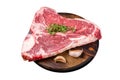 Raw Porterhouse steak, marbled beef meat on a wooden board. Isolated on white background. Royalty Free Stock Photo