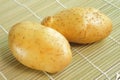 Raw potato on bamboo mat Royalty Free Stock Photo