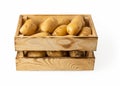 Raw potato tubers in a wooden crate isolated on a white background. Fresh yellow potatoes in a wooden box. Rustic style container Royalty Free Stock Photo