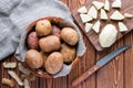 Raw potatoes in the basket, and peeled potatoes Royalty Free Stock Photo