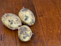Raw potatoes on brown table Royalty Free Stock Photo