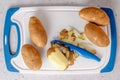 Raw potatoes on cutting board, and vegetable peeler close-up, flat lay with copy space Royalty Free Stock Photo