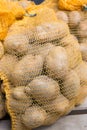 Raw potatoes food in sacks on wood background