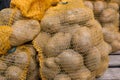 Raw potatoes food in sacks on wood background