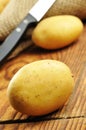 Raw potatoes in jute sack, selective focus