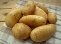 Raw potatoes on the kitchen towel, rustic style