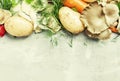 Raw potatoes, oyster mushrooms, carrots, onions, parsley, garlic and dill, food background, top view