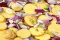Raw potatoes with red onion, garlic and parsley Royalty Free Stock Photo