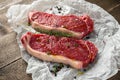 Raw premium beef sirloin steak with thyme and papper corn and sea salt seasoning drizzled with olive oil on cooking Royalty Free Stock Photo