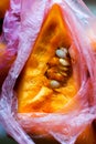 Raw pumpkin piece in plastic bag, zero waste, smart consuming Royalty Free Stock Photo