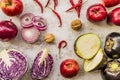 Raw purple vegetables and fruit on white marble background top view